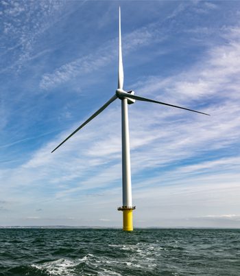 Offshore wind turbine under clear blue sky